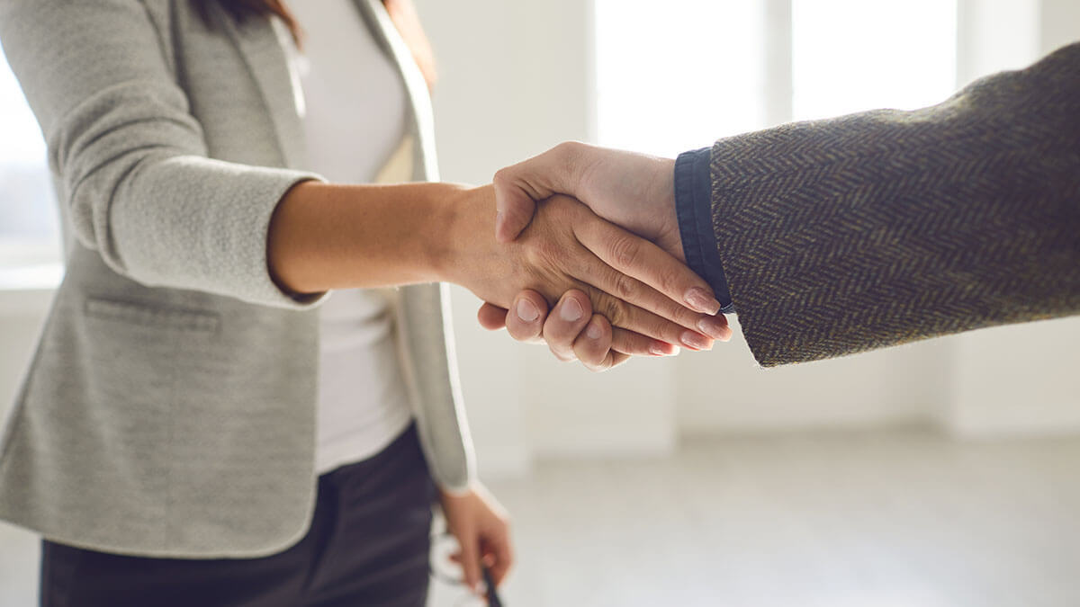 Two stakeholders shaking hands.
