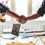 Contractor and business owner shaking hands.