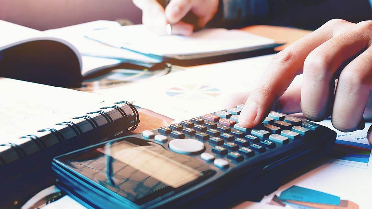 Owner using a calculator to calculate business interest.