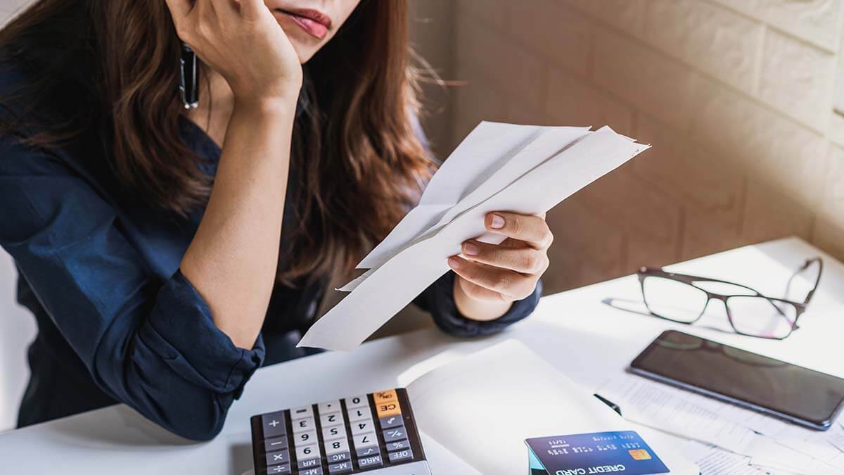 Woman looking at a bookkeeping clean-up checklist.