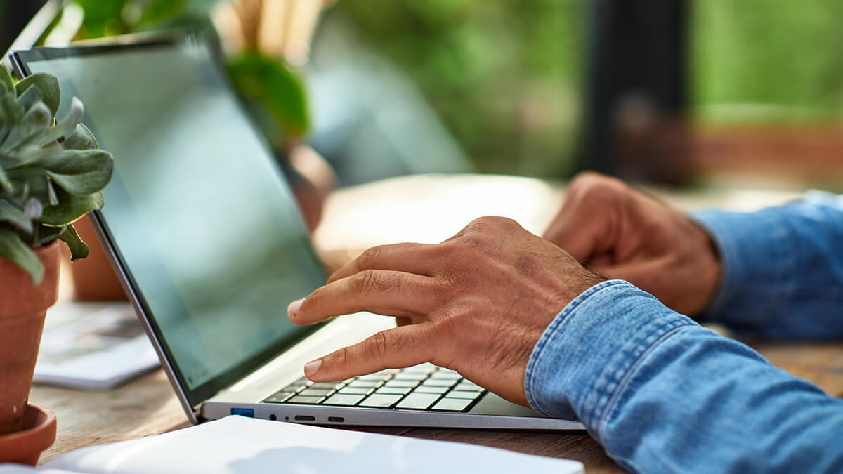 Hands typing on a laptop.