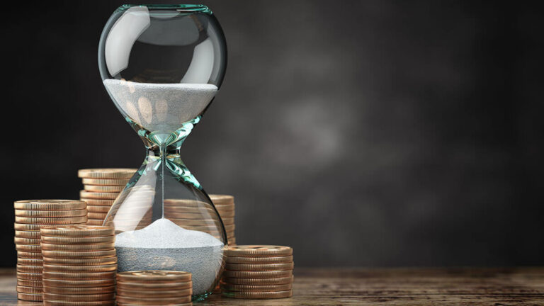 Hourglass surrounded by coins.