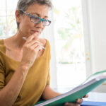 Woman researching state-mandated retirement plans.