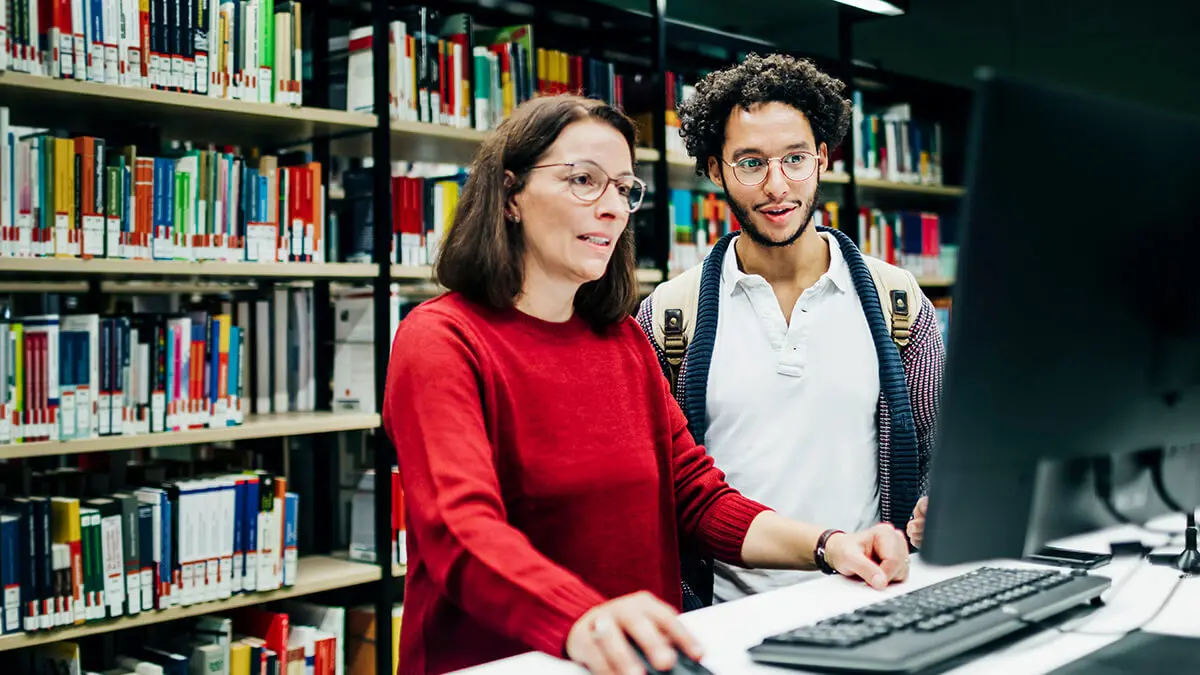 Employees reviewing education assistance