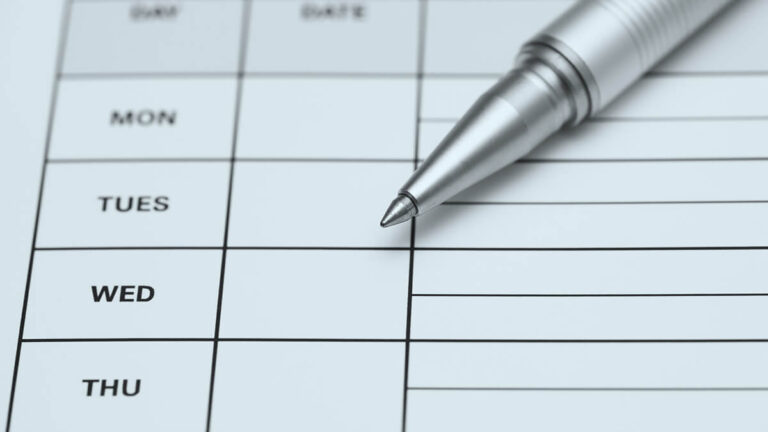 Empty employee timesheet and a pen.