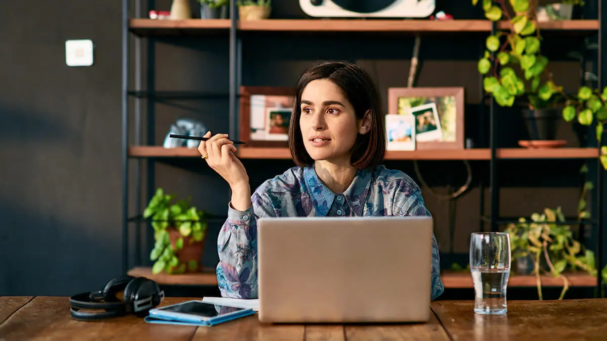 Business owner researching FLSA hours worked on laptop