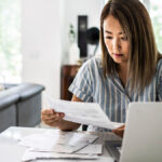 Woman reviewing documents in her living room.