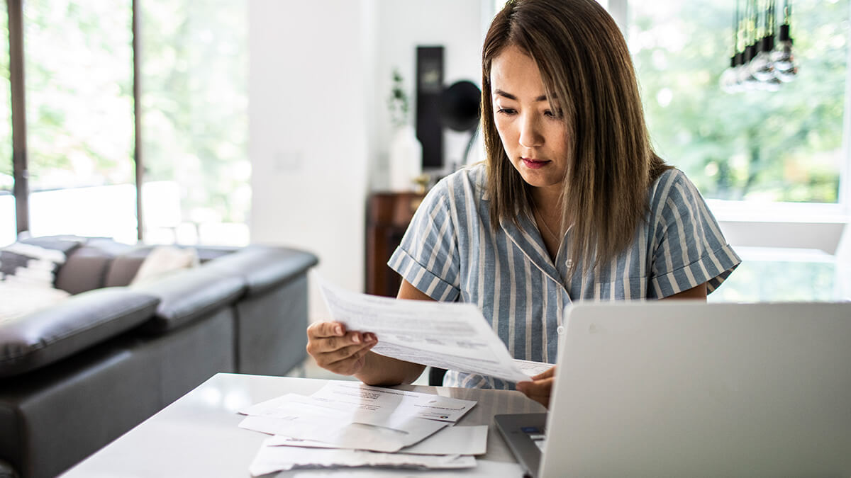 Woman reviewing documents in her living room.