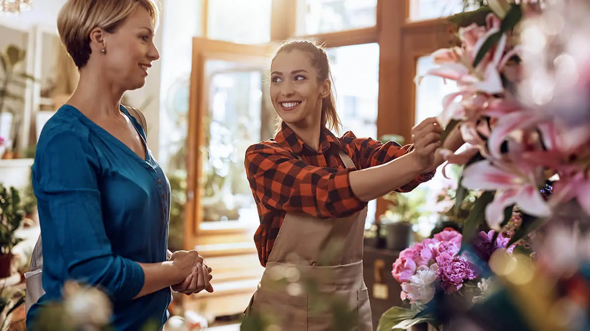 Flower shop employee with a customer