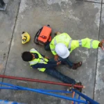 Construction worker on the ground with an injured leg