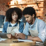 Two workers looking for accounting errors.