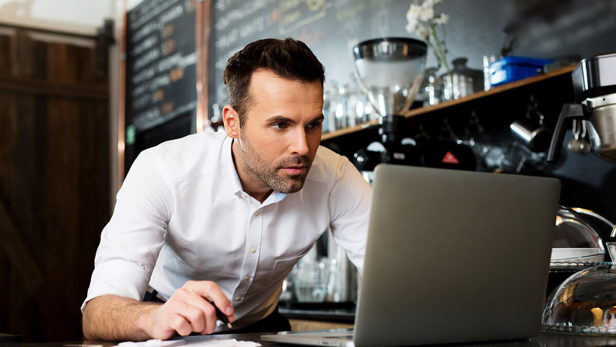 Business owner making correcting entries on laptop.