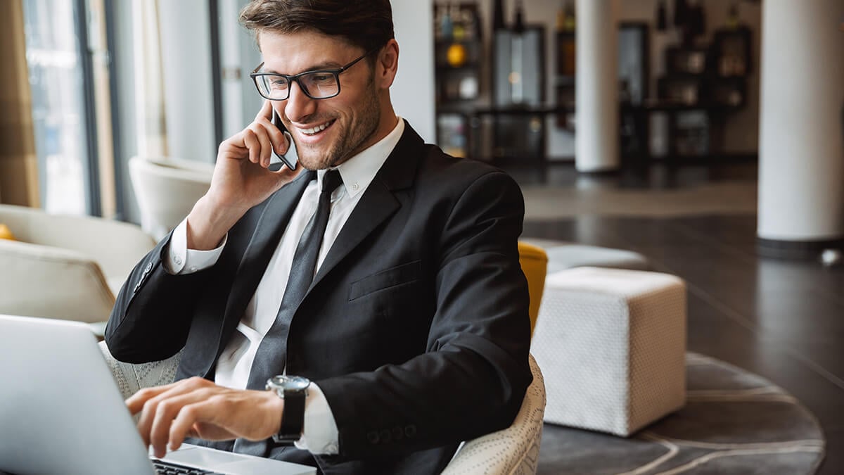 Accountant on the phone and using a computer.