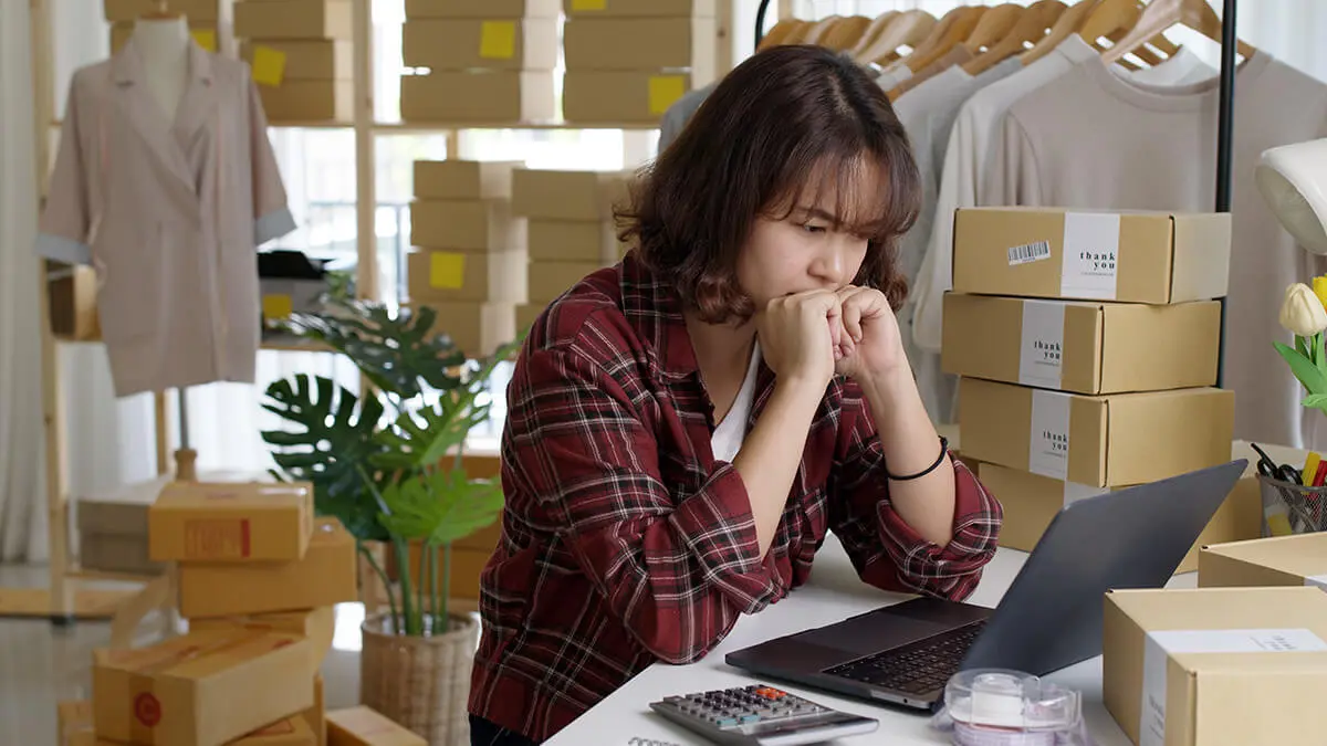 stressed woman looking at laptop