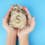 hands holding a small money bag