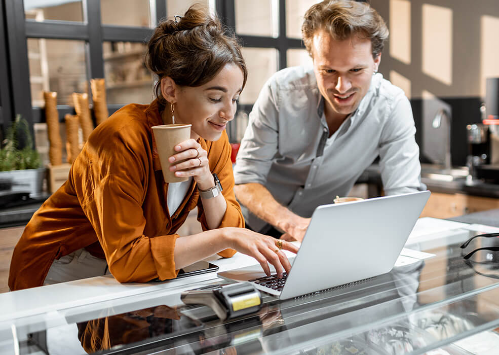 Man and woman looking at a laptop.