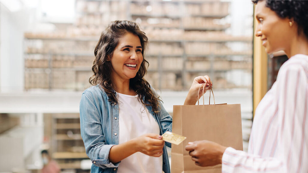 Woman paying for goods with a credit card.