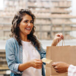 Woman paying for goods with a credit card.