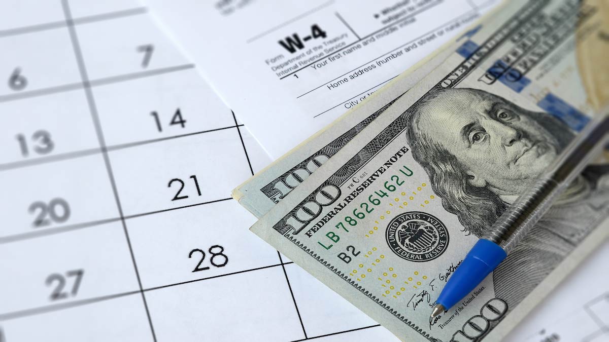 $100 bills, Form W-4, and a calendar.