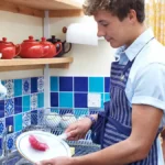 Teen washing dishes at a restaurant