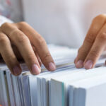 Hands going through files.