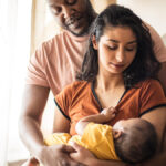Parents holding newborn.
