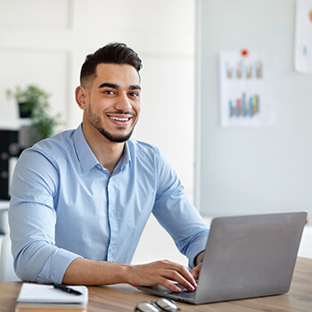 Smiling man using Patriot's accounting and payroll software.