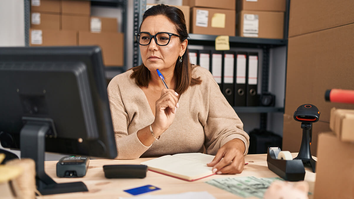 Business owner looking at her desktop computer.