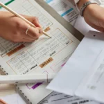 Woman looking at business receipts for taxes.