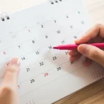 Someone circling a date on a calendar