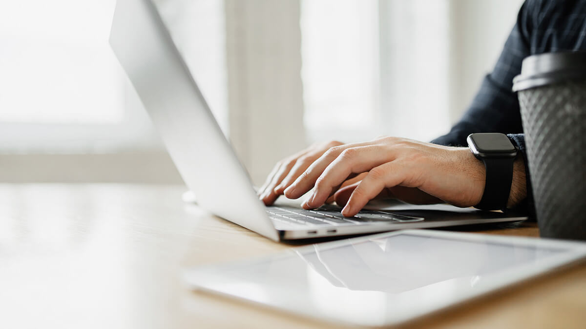 Accountant on a laptop researching CPE credits.