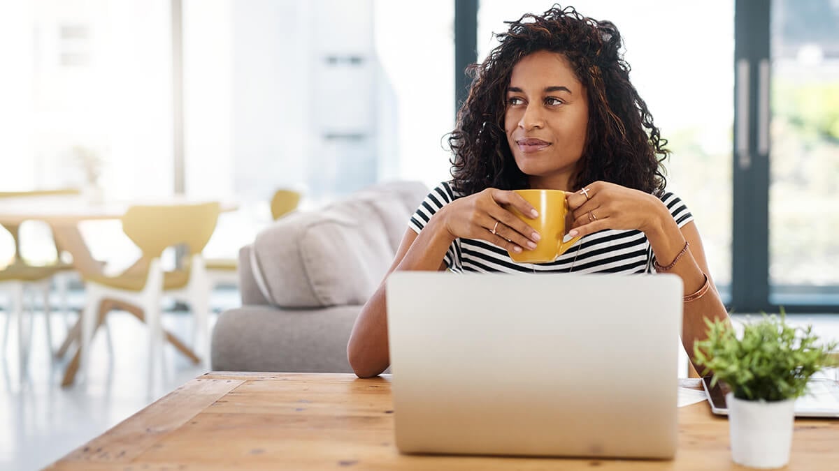 Accountant holding a cup of coffee staring in the distance