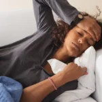 Woman with headache taking California paid sick leave.