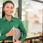 Smiling woman holding laptop
