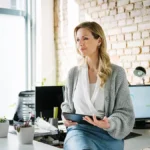 Woman sitting on a table using a tablet