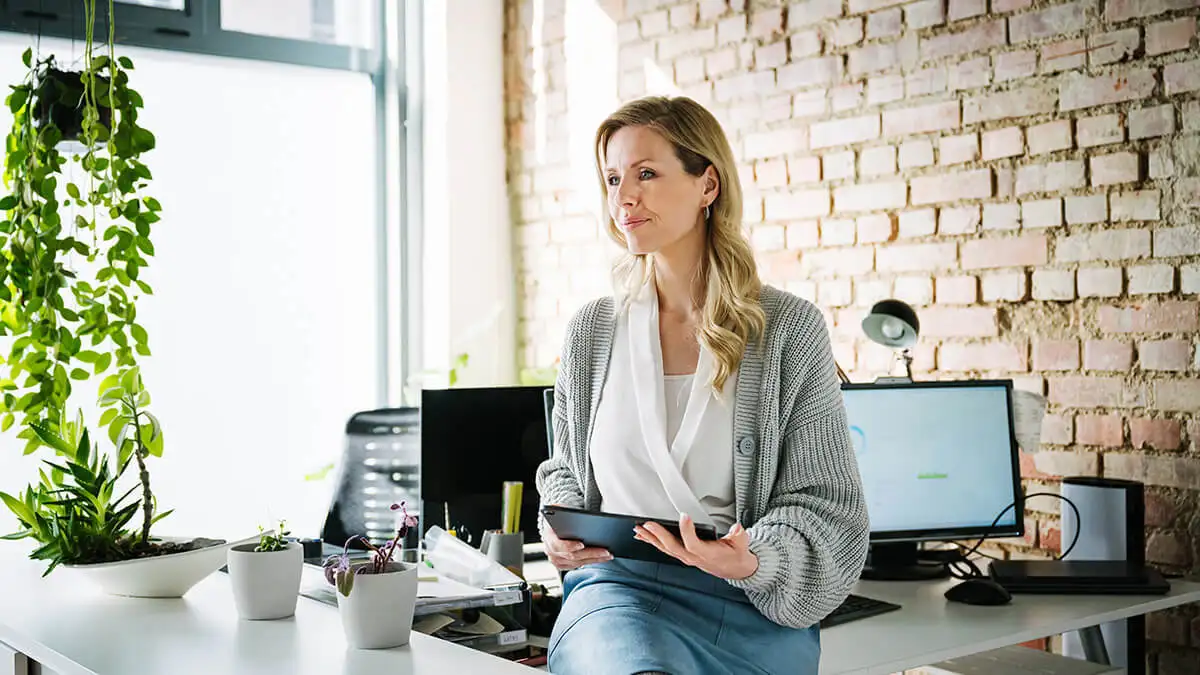 Woman sitting on a table using a tablet