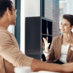 Two co-workers discussing the difference between W-2 employee vs. 1099 contractor.
