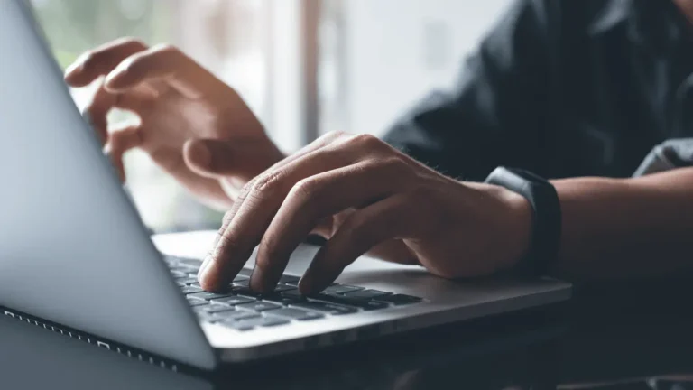 Hands on a laptop