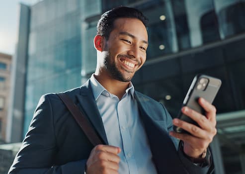 Happy man using phone to check for direct deposit.