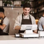 Three workers in a cafe.