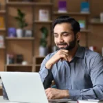 Man looking at HR software for small business on his laptop