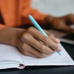 Woman recording 401(k) contribution limits 2025.