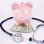 Piggy bank, money, and stethoscope