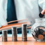 Man adding change into a bowl to represent Colorado retirement savings.