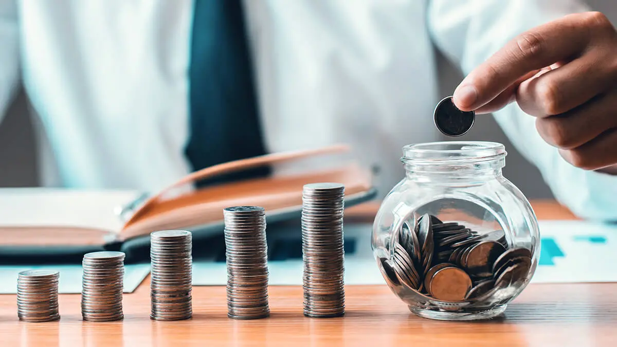 Man adding change into a bowl to represent Colorado retirement savings.