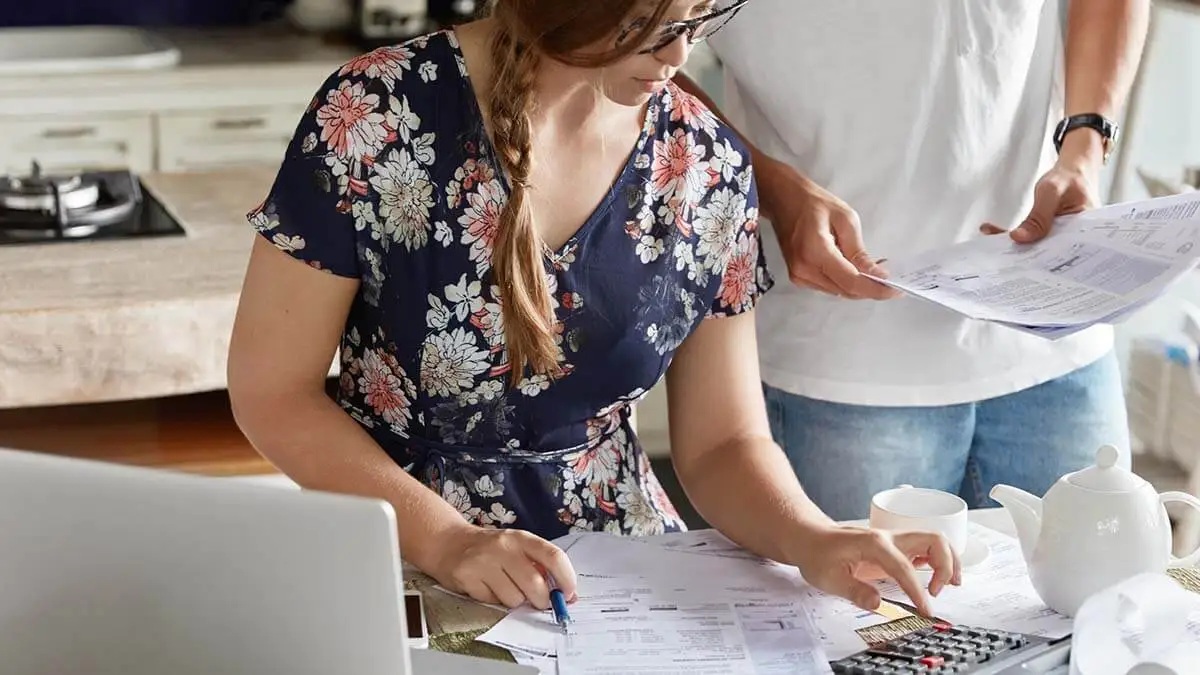 Two employees review net income vs. gross income