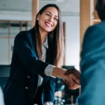 Accountant shaking hands with business partners.