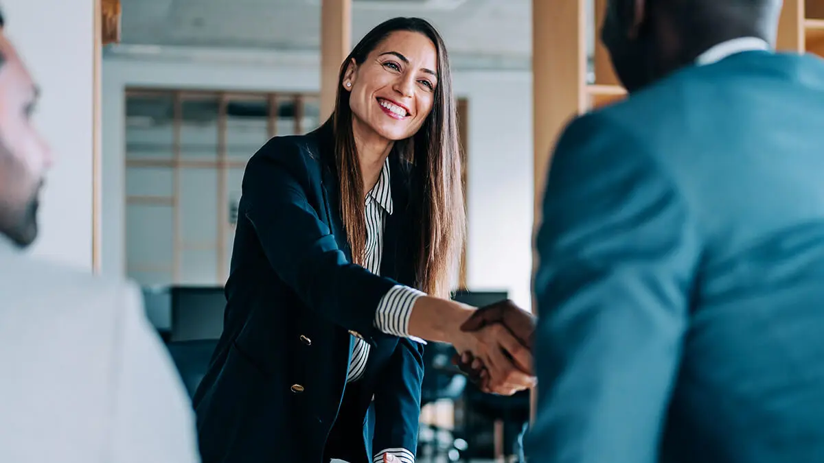 Accountant shaking hands with business partners.