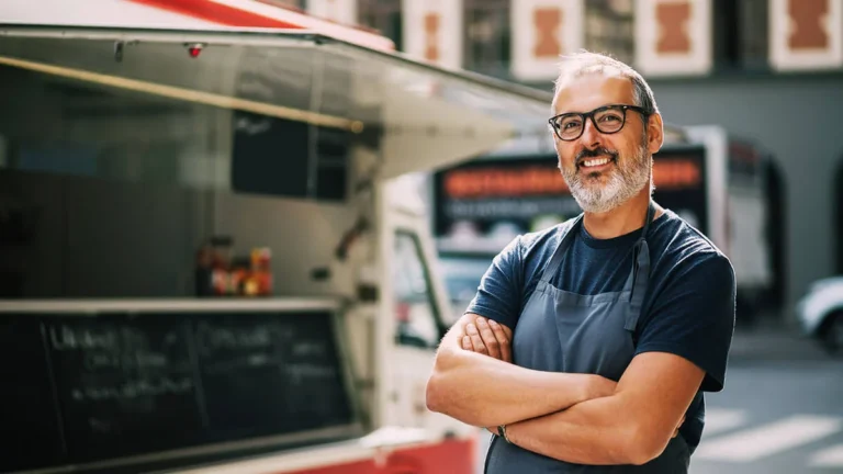 Microbusiness owner in front of his food truck.