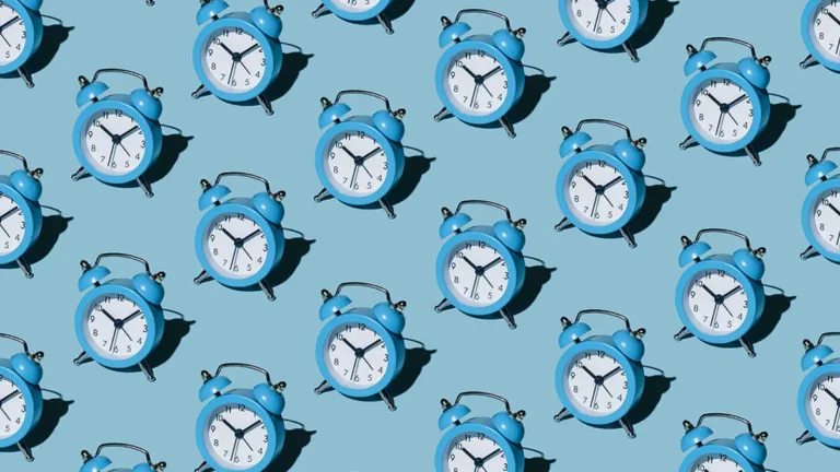 Rows of blue clocks on a blue background.